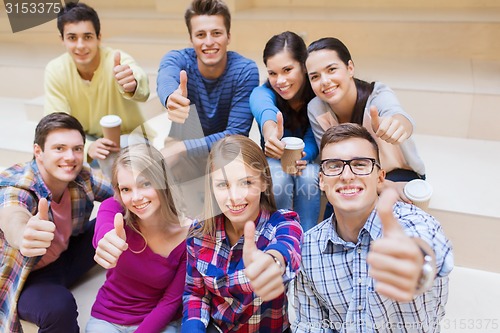 Image of group of smiling students with paper coffee cups