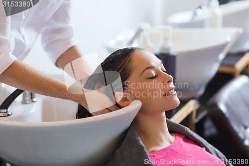 Image of happy young woman at hair salon