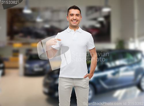 Image of smiling man in t-shirt pointing finger on himself