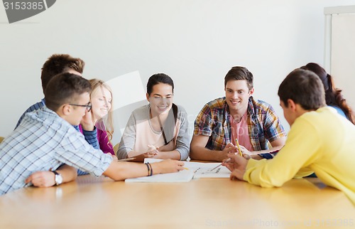 Image of group of smiling students with blueprint