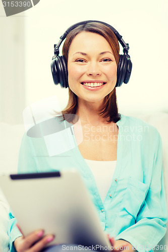 Image of smiling woman with tablet pc and headphones