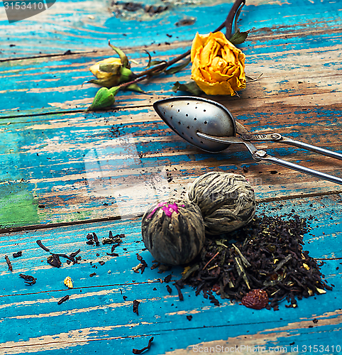 Image of Tea leaves for brewing,tea spoon and dried yellow rose