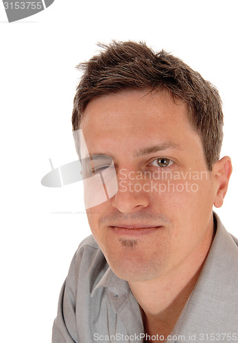 Image of Man closing one eye.