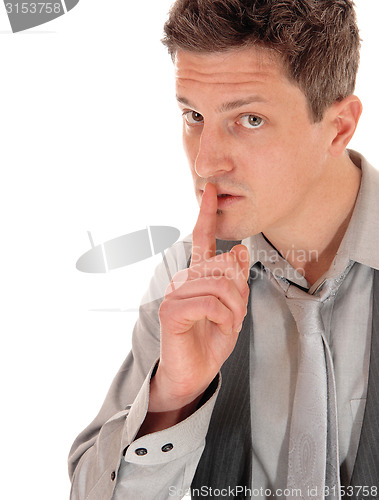 Image of Closeup man with finger on mouth.