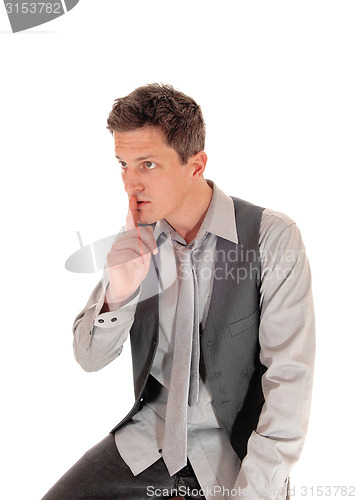 Image of Man with finger over mouth.