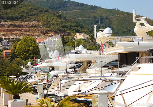 Image of Row of luxury motorised yachts moored in a sheltered harbour