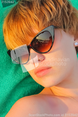 Image of woman relaxing on the beach.