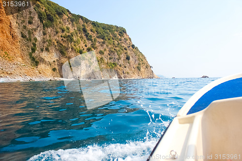 Image of boat floats near the shore.