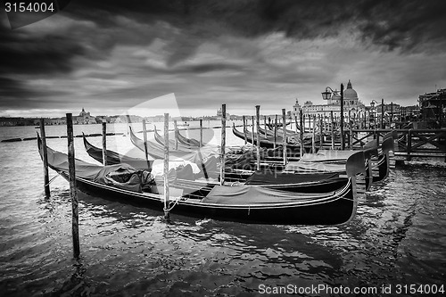 Image of Gondolas with view of Santa Maria della Salute at sunset bw