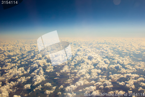 Image of White clouds in blue sky. Aerial view from airplane.