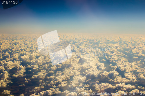 Image of White clouds in blue sky. Aerial view from airplane.