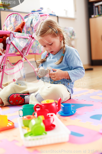 Image of Cute girl playing with toys