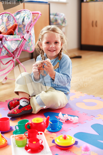 Image of Cute girl playing with toys
