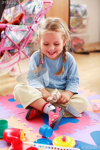 Image of Cute girl playing with toys