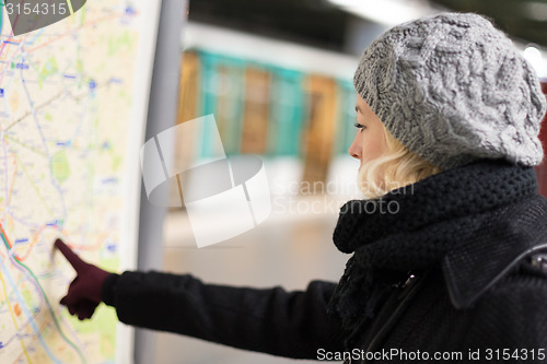 Image of Lady looking on public transport map panel.