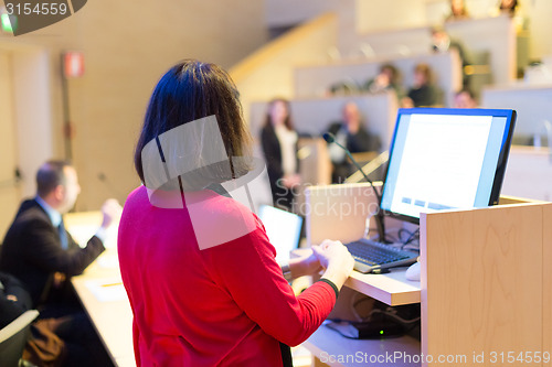 Image of Female speaker at Business Conference.