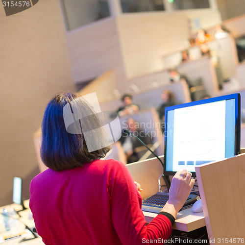 Image of Female speaker at Business Conference.