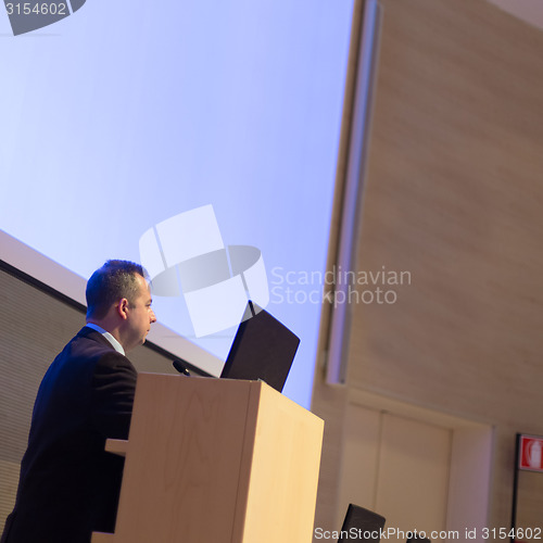 Image of Speaker giving talk on podium at Business Conference.