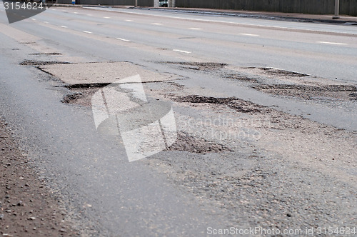 Image of Big hole in street asphalt