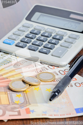 Image of Calculator and money on the table