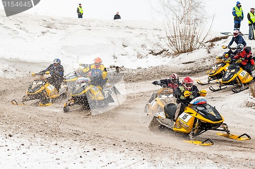 Image of Snowmobiles moves on bend of sport track