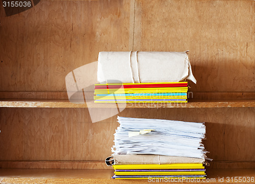 Image of File folders, sheets of paper on the shelve