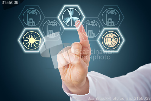 Image of Male Hand Activating Renewable Energy Icons
