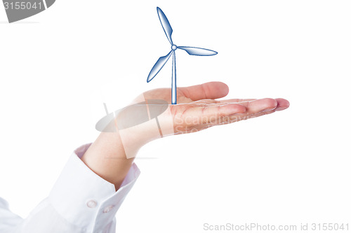 Image of Wind Turbine Rising In The Palm Of A Hand