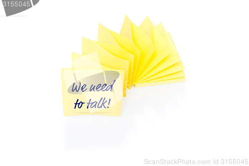 Image of Yellow sticky note on block with message We Need To Talk