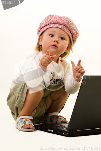 Image of Adorable baby with laptop