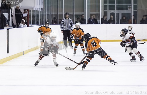 Image of Game between children ice-hockey teams