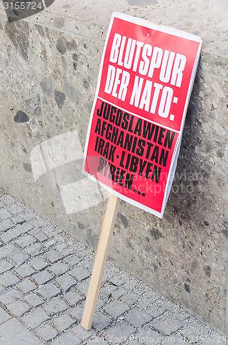 Image of Protest sign placard anti-NATO rally demonstration against NATO 