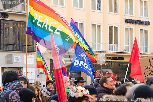 Image of European peaceful march with flags placards and banners