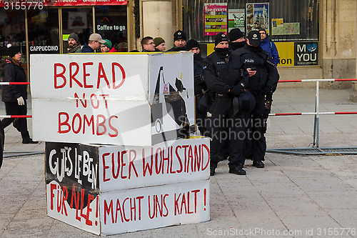 Image of Police cordon and signs banners on protest rally anti-NATO demon