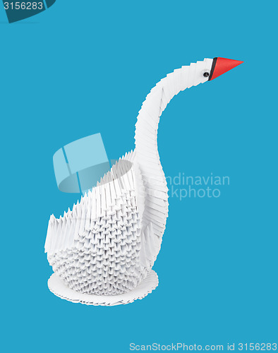 Image of white swan on blue background. figure of bird out of paper