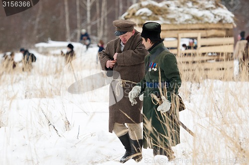 Image of Civilian and soldier walking