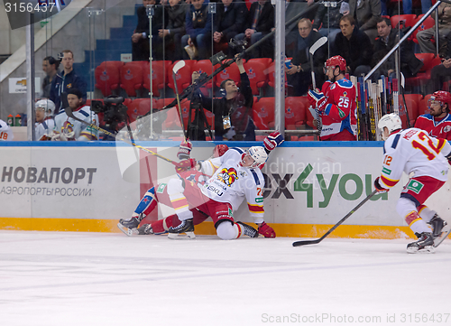 Image of E. Sallinen (76) and A. Stas (23) fall down