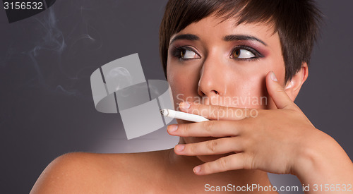 Image of Young Woman Inhales Cigarette Smoke INtimate Smoker Portrait