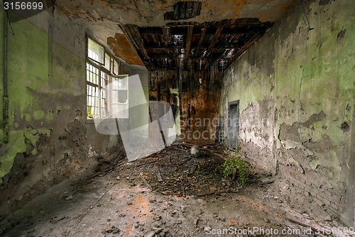 Image of Dark room interior with damaged roof