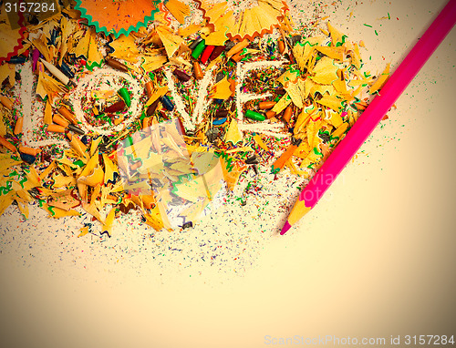 Image of The word Love on colored pencil shavings