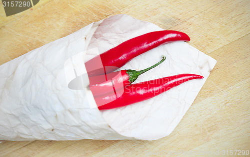 Image of red hot chili peppers in paper bags