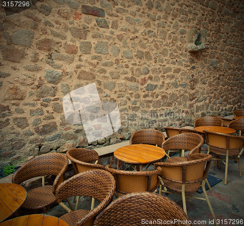 Image of summer cafe near the ancient stone wall