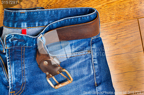 Image of blue jeans with a leather belt