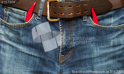 Image of old jeans with red chili pepper 