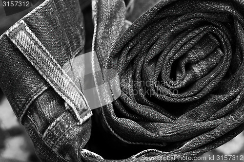 Image of jeans constricted into a roll