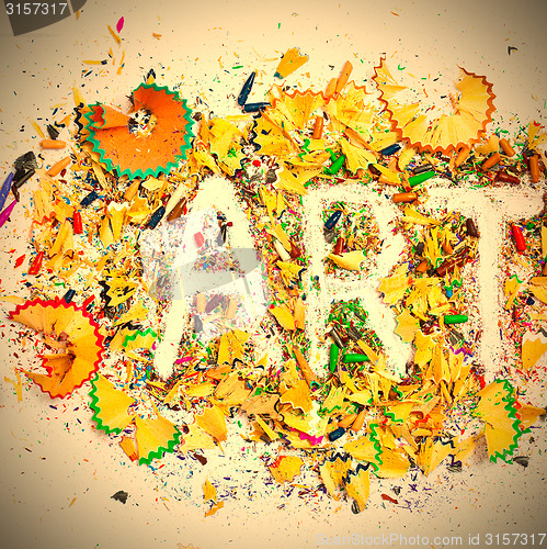 Image of word Art over a colored shavings of pencils
