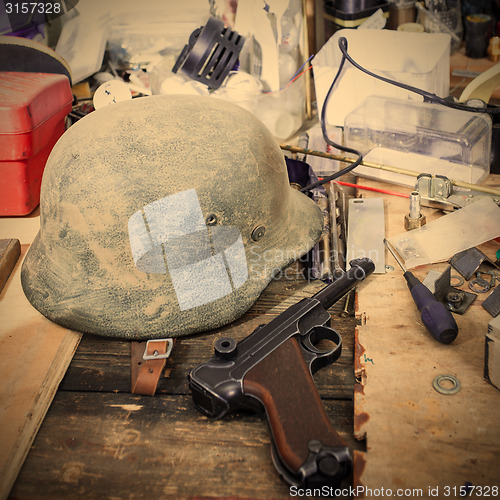 Image of Parabellum and vintage German soldier helmet