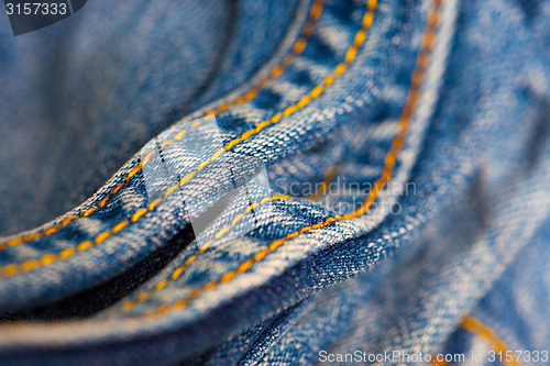 Image of Jeans with yellow stitching thread