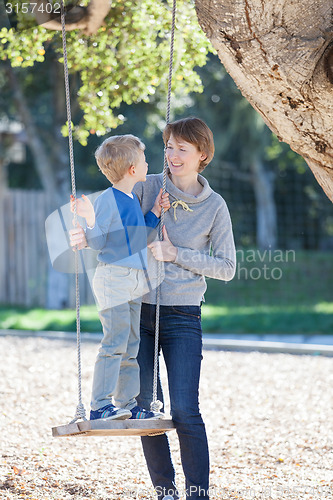Image of family at swings