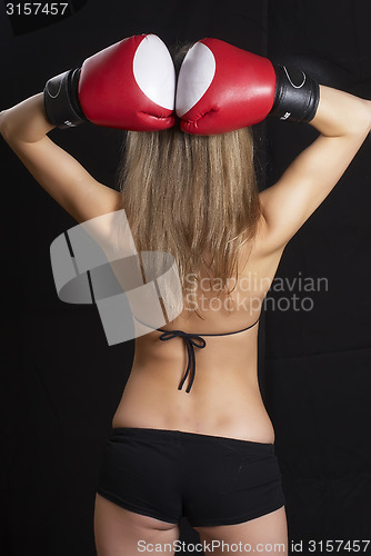 Image of Back of pretty girl with boxing gloves